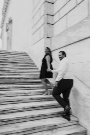 A blurry picture of a man and a woman walking up stairs holding hands