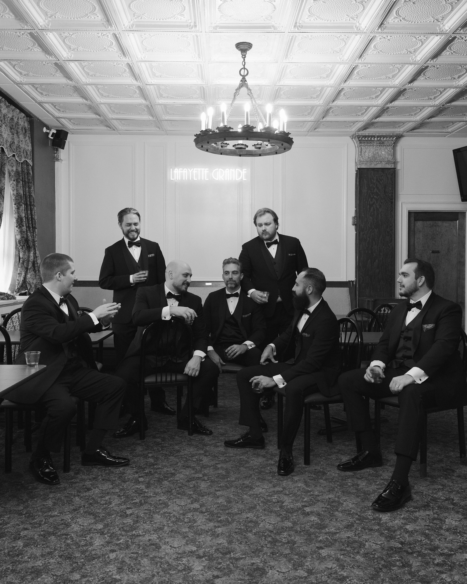 Groomsman getting ready and sharing a drink together at The Lafayette Grand in Pontiac, Michigan