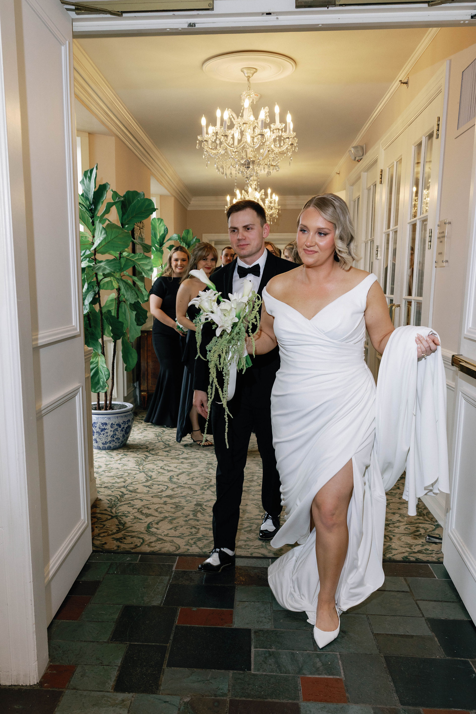 The bride and group after their ceremony walking out in celebration