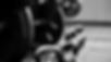 barbell and kettlebells on the ground in grayscale color.jpg