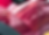 Reflection of a hand on a shiny red car surface with smooth curves. The background includes abstract patterns and soft lighting.