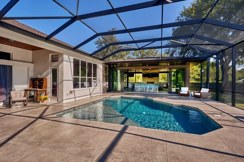 An attractive outdoor living space and pool house capture the essence of leisure and comfort in Tampa Bay.