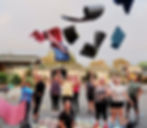 Happy Bootcampers throwing yoga mats