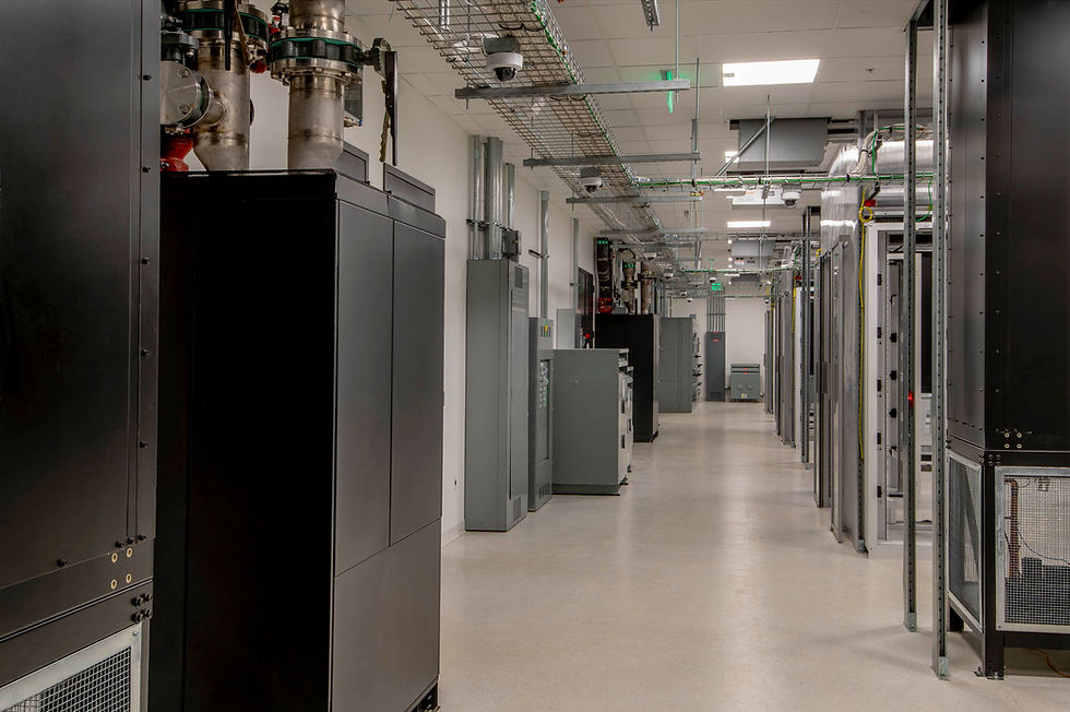 Long data center aisle with server racks and overhead cabling infrastructure.