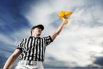 referee holding up yellow flag