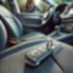 A woman looking through her car window as her key is locked inside