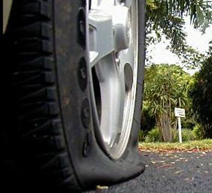 flat tire on the side of the road