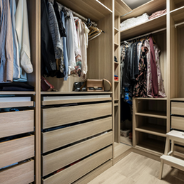 Well-organized walk-in closet with clothes and drawers