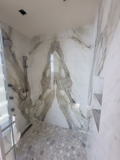 Modern shower with natural granite walls.
