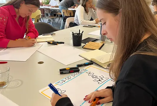 deelnemers tekenen een template tijdens een training visuele werkvormen