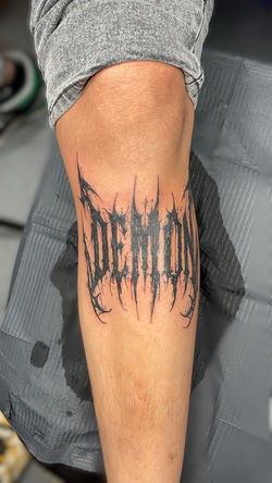 Lettering on arm 'Demon'