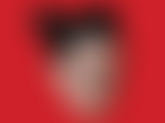 The disembodied head of a caucasian woman with brown hair on a flat red background