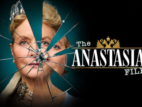 A regal woman in jewels is reflected in a shattered mirror.