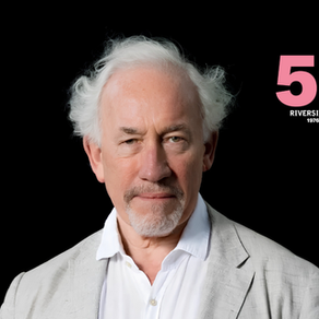 Actor Simon Callow, a white haired gentleman in a shirt, on a black background