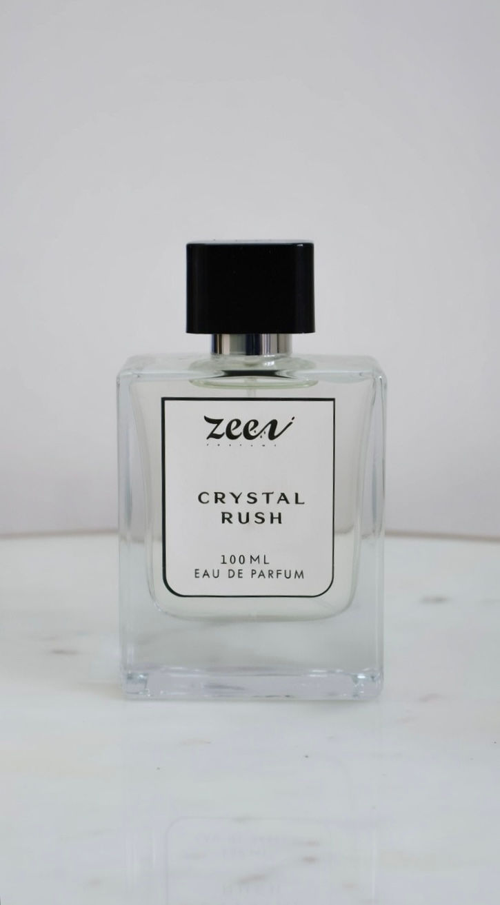 Clear glass Zeca CRYSTAL WOOD EAU DE PARFUM bottle with black cap.