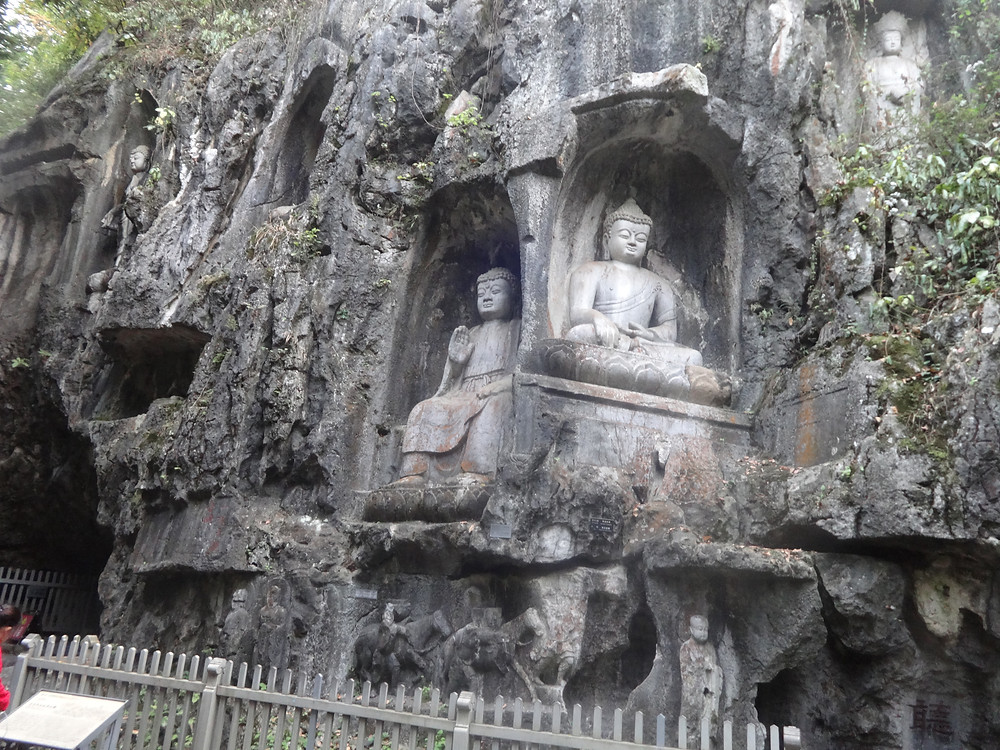Buddha's carved into the foot of a mountain