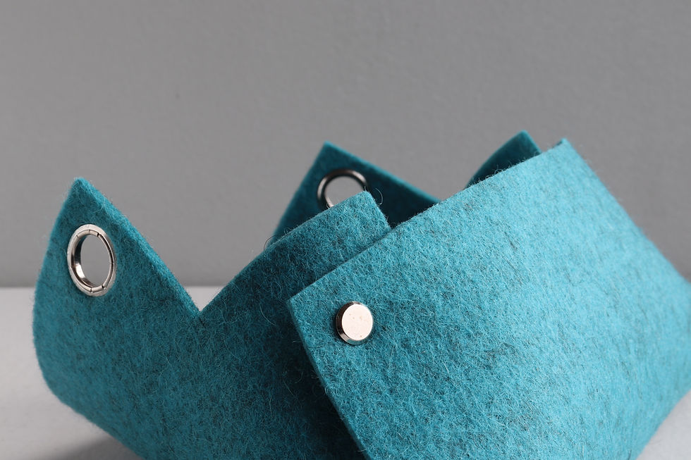 a turquoise blue felt mail organizing basket is sitting on a table