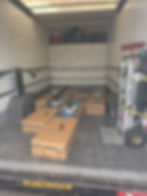 Boxes and a hand truck inside a moving van for Hart's Removals.