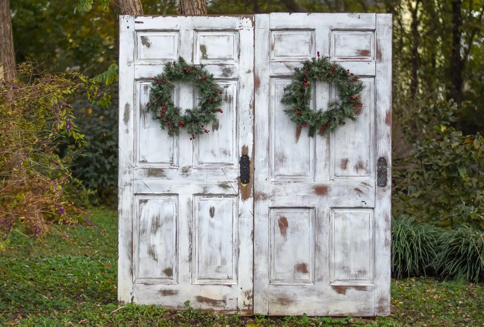 Two white doors with Christmas wreaths on them at a Christmas farm in Murfreesboro TN