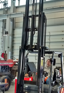 Student operating forklift.