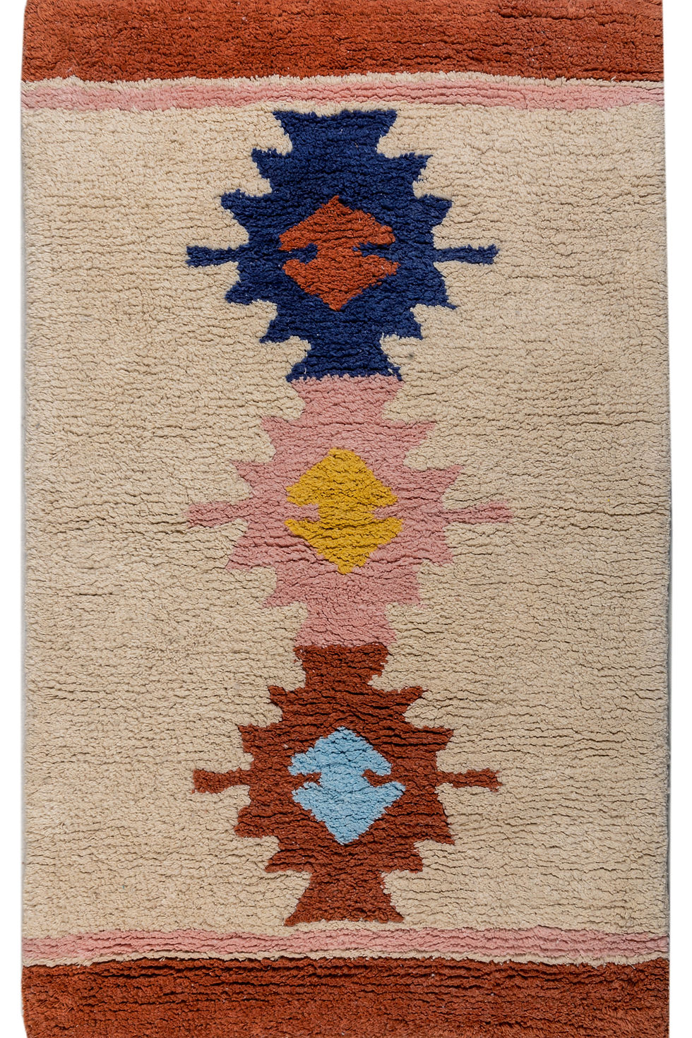Textured rug with geometric patterns in red, blue, yellow, and pink on a beige background. Broad red and pink borders frame the design.