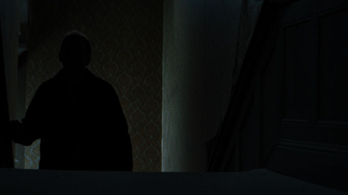 A dark silhoette of a man on the stairs