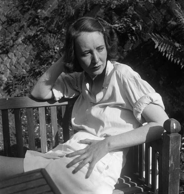 Mary Oliver sitting on a bench, without a Capri-Sun.