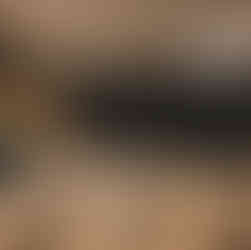 Feather wand, canvas bags, and aquamarine crystals displayed on a black table cloth