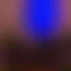 Three water kettles sitting on the ground in front of a blue galaxy light display