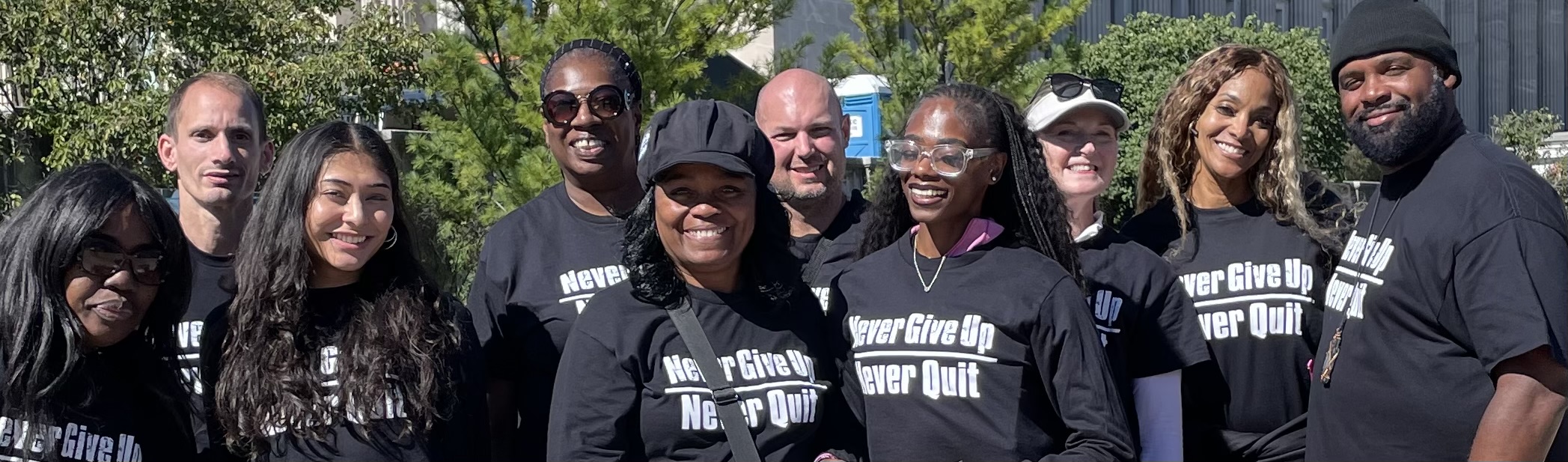Never Give Up Never Quit volunteers gathered together outdoors
