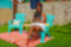 Thumbnail: Woman reading a book on a chair outdoors