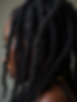 A detailed, close-up shot focusing on the intricate pattern of Sisterlocks, emphasizing te