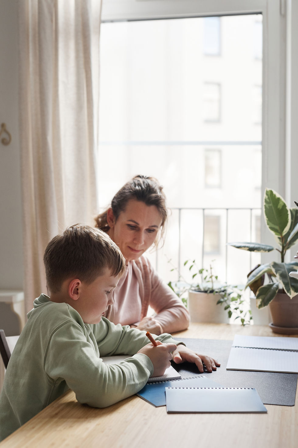 mother-son-doing-homework-together-side-view.jpg