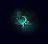 Glowing green and blue nebula in deep space