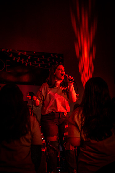 Photo of girl singing at a concert