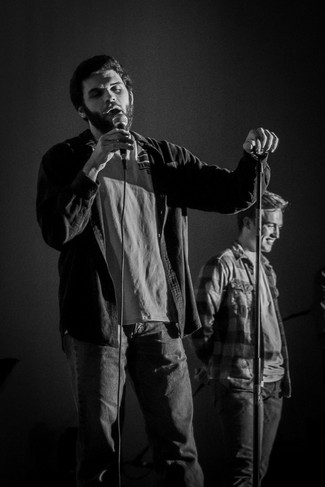 Black and white photo of man singing at a concert