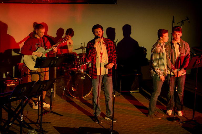 Photo of man singing at a concert