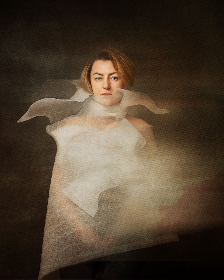 Self-portrait with translucent fabric unevenly twisted around the neck and torso, creating a sense of imbalance and disrupted structure.