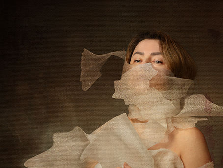 Portrait with fragmented translucent fabric across the face and torso, forming overlapping layers rather than a continuous wrap.