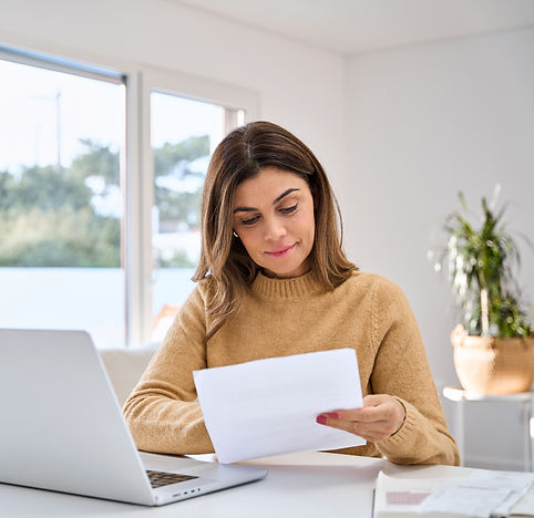 Woman at her desk reconciling her investment accounts