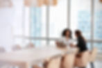 Two women sitting in a board room dsicussing private credit investments