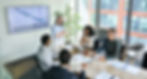 A group of advisors discussing analytics in an office building.