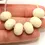 Thumbnail: Ivory rondelle beads 12mm with lava textured