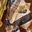 Thumbnail: silk scarf with three brooches in browns and golds