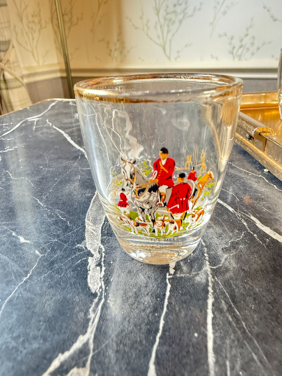 Thumbnail: close up of vintage shot glass with hunting scene