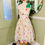 Thumbnail: cream flock floral print dress with narrow straps boned bodice with net skirts. Front view