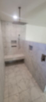 Spacious white tile flooring installed in a handicap-accessible design, offering both style and functionality for ease of movement and accessibility.