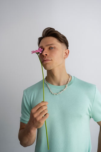 medium-shot-man-posing-with-flower.jpg