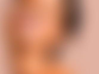 Woman smiling in an orange top
