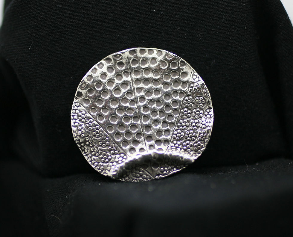 Thai silver circular bead with a curved ridge, frilly edges and unique cobbled/circle textures